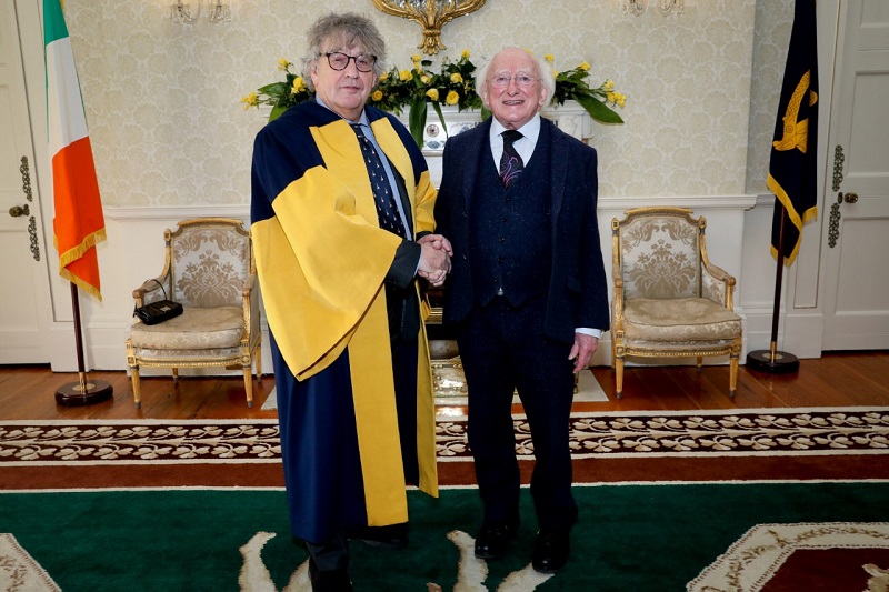 President Higgins and Professor Paul Muldoon shake hands at Áras an Uachtaráin